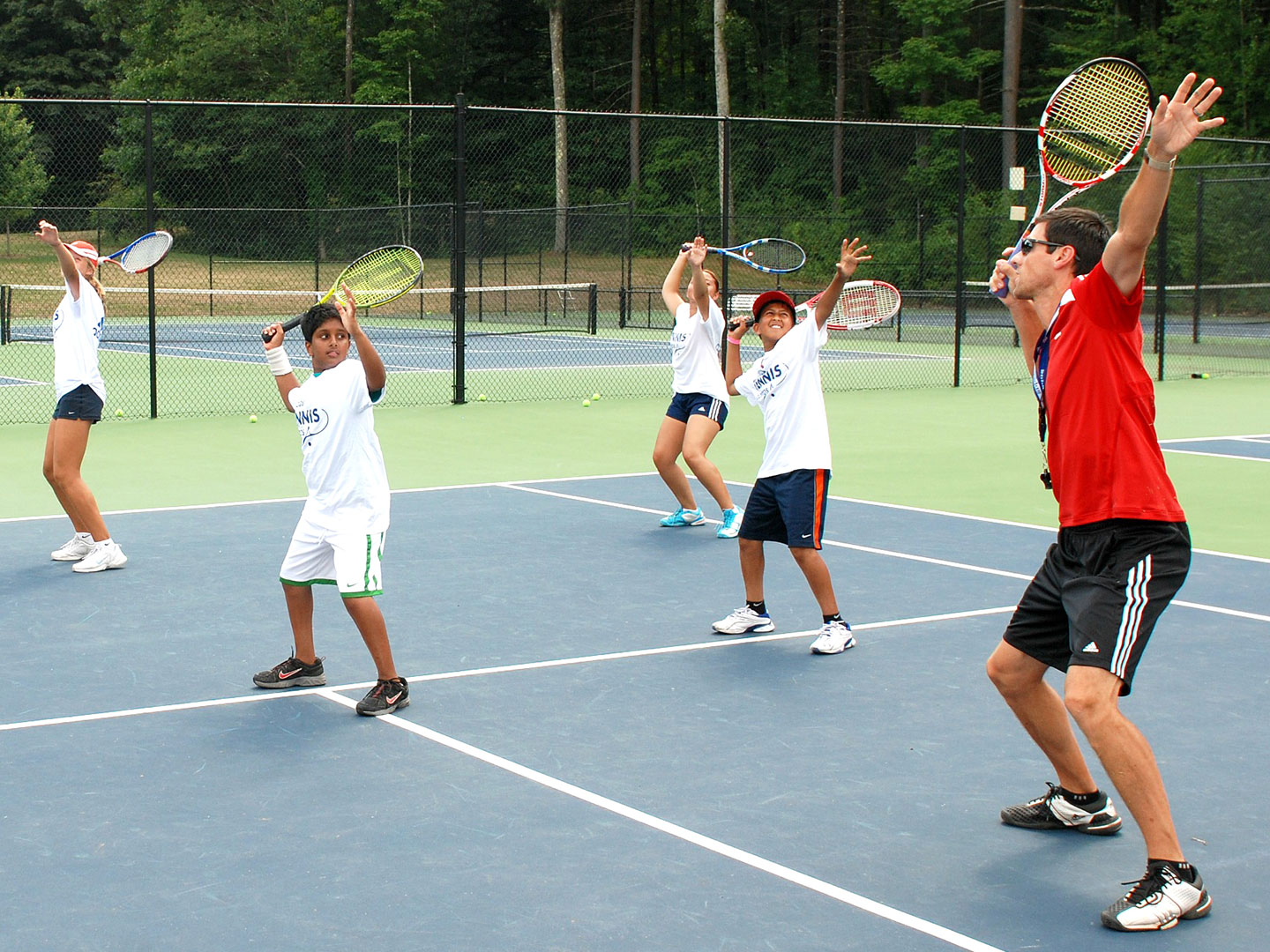 Tennis Camp Coach gives swing feedback