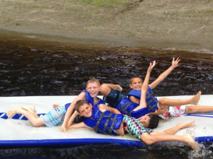 summer campers having fun on the lake