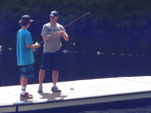 Coach fishing with a camper