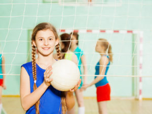Volleyball girl at net with ball